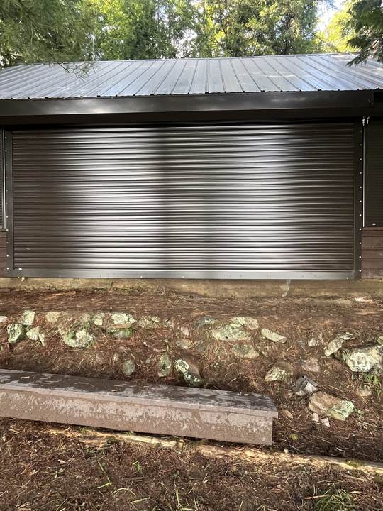 Close view of a silver roll shutter on a brown building